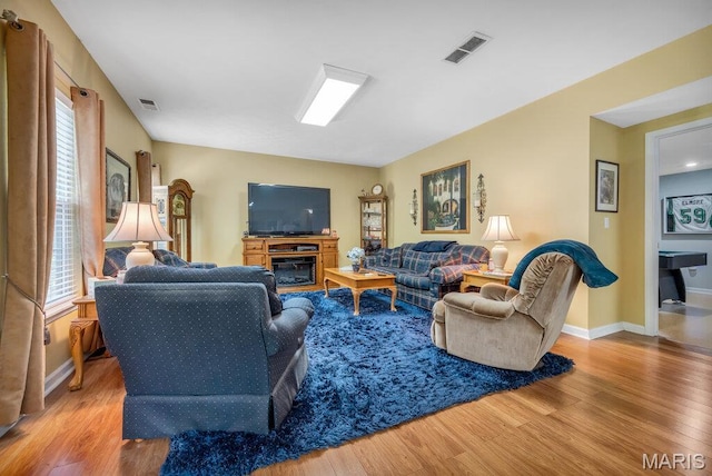 1020 Oak Creek Ln, Waterloo, IL 62298 - living area with wood finished floors, plenty of natural light, and baseboards