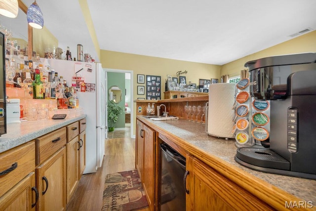 1020 Oak Creek Ln, Waterloo, IL 62298 - indoor dry bar featuring light wood-type flooring, black dishwasher, and freestanding refrigerator