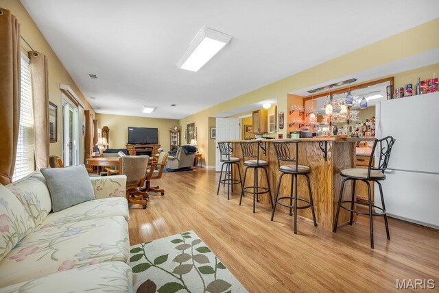 1020 Oak Creek Ln, Waterloo, IL 62298 - living room featuring light wood-type flooring and a bar