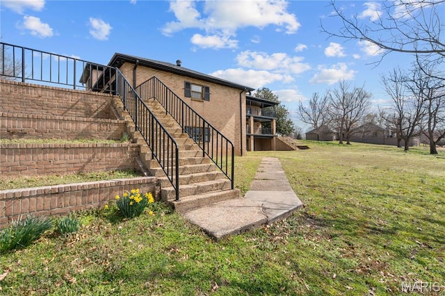 305 Ridge Dr, Sikeston, MO 63801 - rear view of house with stairs, a yard, and brick siding