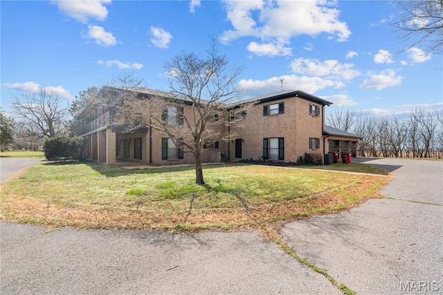 305 Ridge Dr, Sikeston, MO 63801 - view of property exterior with a yard, brick siding, and asphalt driveway