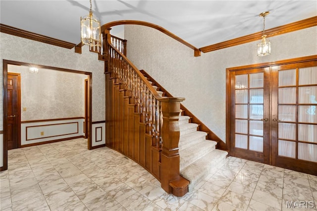 305 Ridge Dr, Sikeston, MO 63801 - stairs featuring ornamental molding, french doors, marble look tiles, and a chandelier