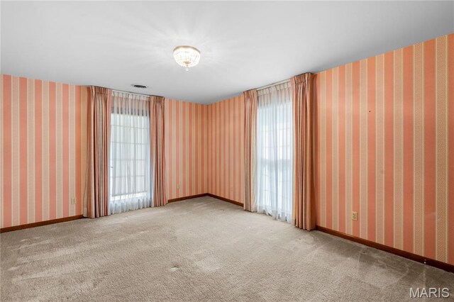 305 Ridge Dr, Sikeston, MO 63801 - carpeted spare room featuring plenty of natural light and baseboards