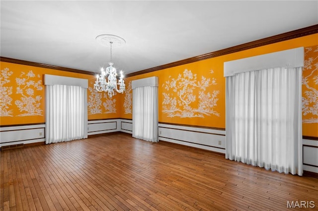 305 Ridge Dr, Sikeston, MO 63801 - unfurnished room featuring wallpapered walls, a chandelier, wainscoting, hardwood / wood-style floors, and ornamental molding