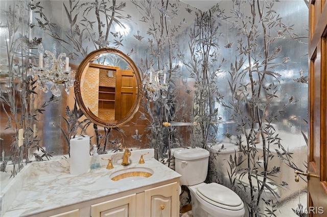 305 Ridge Dr, Sikeston, MO 63801 - half bath featuring vanity, wallpapered walls, and toilet