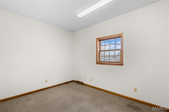 305 Ridge Dr, Sikeston, MO 63801 - spare room featuring baseboards and carpet flooring