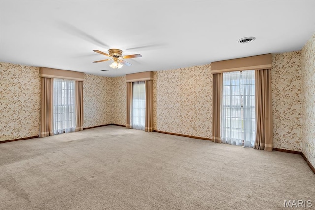 305 Ridge Dr, Sikeston, MO 63801 - carpeted empty room with ceiling fan, healthy amount of natural light, and wallpapered walls