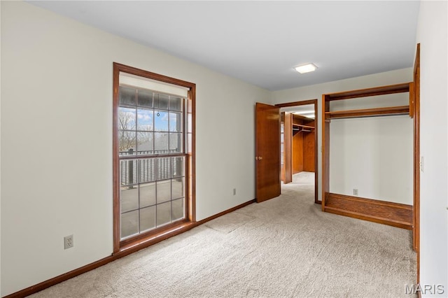 305 Ridge Dr, Sikeston, MO 63801 - unfurnished bedroom featuring carpet floors, baseboards, a closet, and a walk in closet
