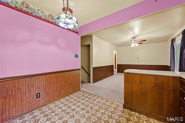 1466 Friar Tuck Ln, Lemay Township, MO 63125 - unfurnished room with wainscoting, wood walls, light carpet, and ceiling fan