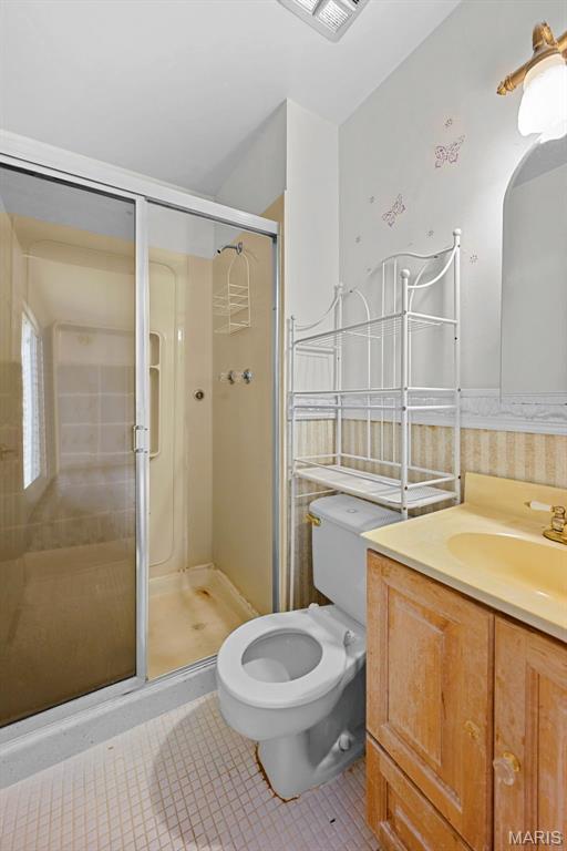 1466 Friar Tuck Ln, Lemay Township, MO 63125 - full bath featuring tile patterned floors, vanity, and a shower stall
