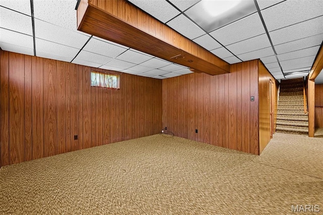 1466 Friar Tuck Ln, Lemay Township, MO 63125 - basement featuring carpet floors, a drop ceiling, wood walls, and stairway