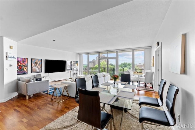 4909 Laclede Ave Unit 806, Saint Louis, MO 63108 - dining room featuring wood finished floors, floor to ceiling windows, and a textured ceiling