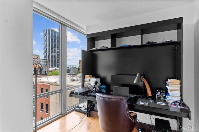 4909 Laclede Ave Unit 806, Saint Louis, MO 63108 - office area featuring healthy amount of natural light, wood finished floors, and expansive windows