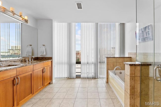 4909 Laclede Ave Unit 806, Saint Louis, MO 63108 - full bathroom with vanity, a garden tub, tile patterned flooring, and a stall shower