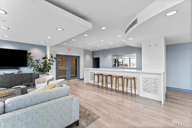 4909 Laclede Ave Unit 806, Saint Louis, MO 63108 - living room with wood finished floors, recessed lighting, and french doors