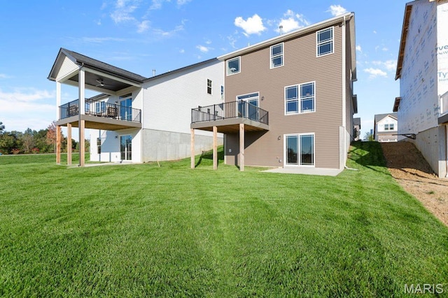 543 Wheatfield Cir, Ofallon, MO 63385 - rear view of property featuring a lawn, a balcony, and ceiling fan