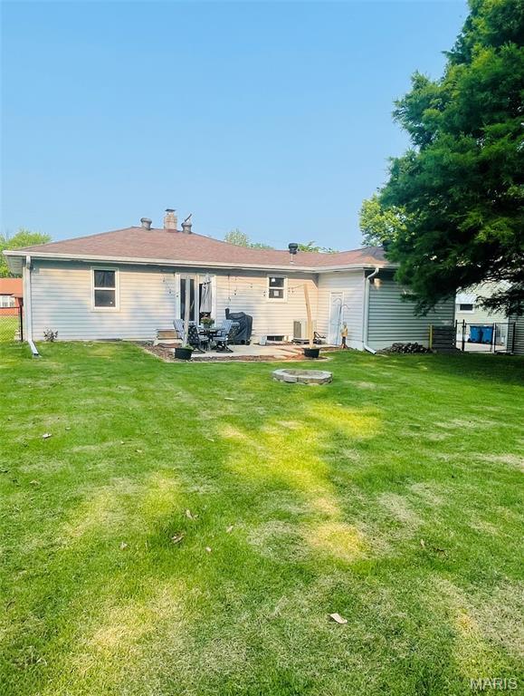 111 Elm St, Cottage Hills, IL 62018 - back of property featuring a patio, a yard, and a chimney