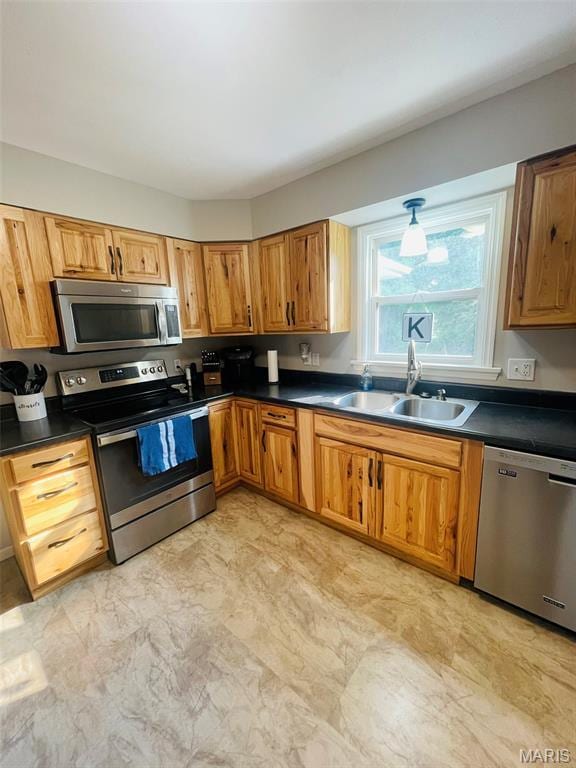 111 Elm St, Cottage Hills, IL 62018 - kitchen featuring stainless steel appliances, a sink, dark countertops, and brown cabinets