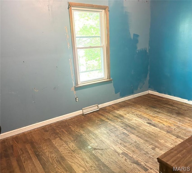 450 N Main St, Saint Clair, MO 63077 - empty room featuring wood finished floors, healthy amount of natural light, and baseboards