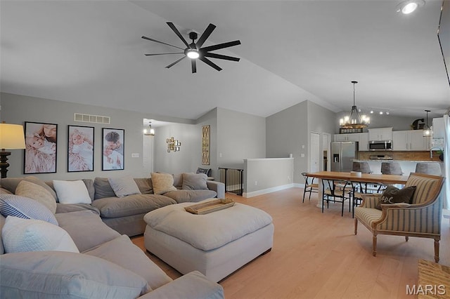 3837 Bedford Pointe Dr, Wentzville, MO 63385 - living area with lofted ceiling, a chandelier, a ceiling fan, and light wood-type flooring