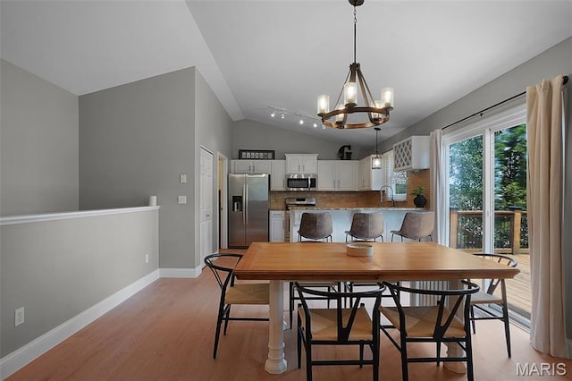 3837 Bedford Pointe Dr, Wentzville, MO 63385 - dining area featuring vaulted ceiling, a chandelier, and light wood finished floors