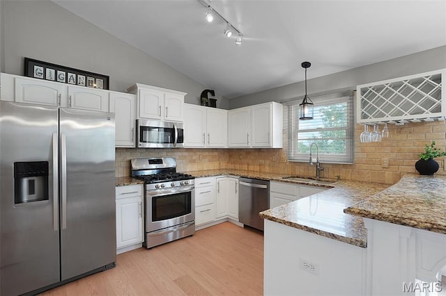 3837 Bedford Pointe Dr, Wentzville, MO 63385 - kitchen featuring appliances with stainless steel finishes, white cabinets, vaulted ceiling, stone counters, and track lighting