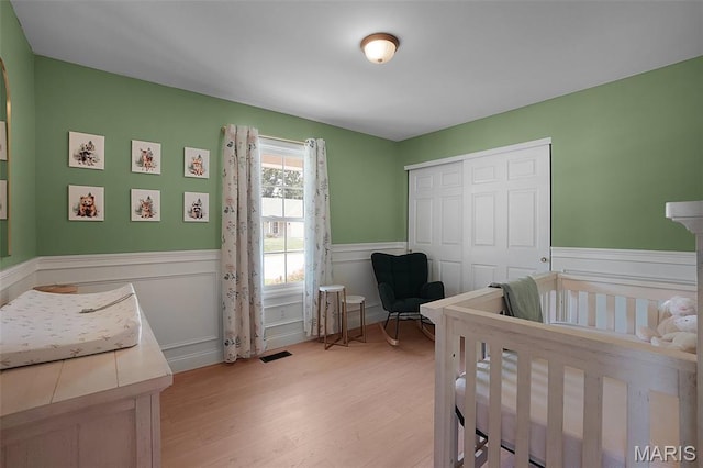 3837 Bedford Pointe Dr, Wentzville, MO 63385 - bedroom with a wainscoted wall, light wood finished floors, and a closet