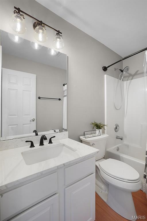 3837 Bedford Pointe Dr, Wentzville, MO 63385 - full bath with vanity, wood finished floors, and shower / tub combo