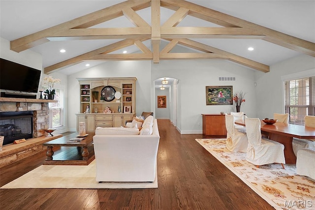 1316 Breezeridge Dr, Des Peres, MO 63131 - living area featuring arched walkways, baseboards, a stone fireplace, recessed lighting, and wood finished floors