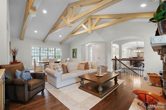 1316 Breezeridge Dr, Des Peres, MO 63131 - living room featuring arched walkways, a chandelier, beam ceiling, wood finished floors, and recessed lighting
