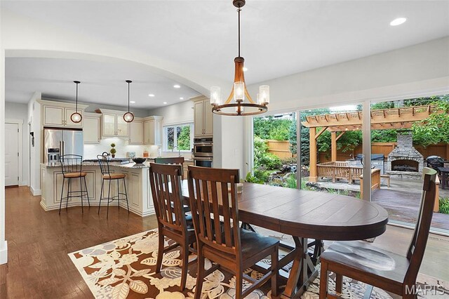 1316 Breezeridge Dr, Des Peres, MO 63131 - dining room with a chandelier, dark wood-style flooring, arched walkways, and recessed lighting