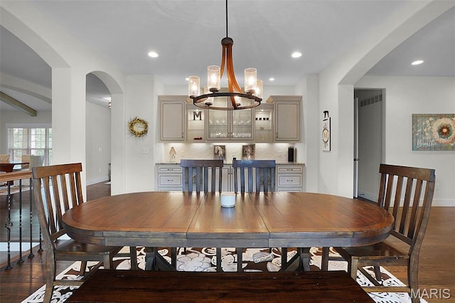 1316 Breezeridge Dr, Des Peres, MO 63131 - dining space featuring arched walkways, baseboards, a chandelier, dark wood-type flooring, and recessed lighting
