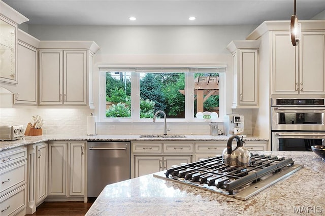1316 Breezeridge Dr, Des Peres, MO 63131 - kitchen featuring stainless steel appliances, a sink, decorative backsplash, recessed lighting, and light stone countertops