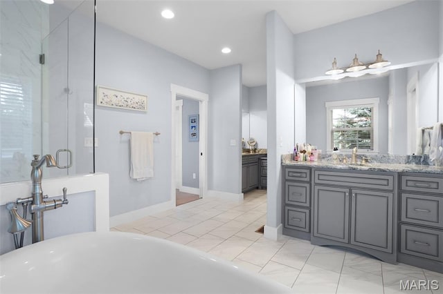1316 Breezeridge Dr, Des Peres, MO 63131 - bathroom with vanity, a freestanding tub, a stall shower, and recessed lighting