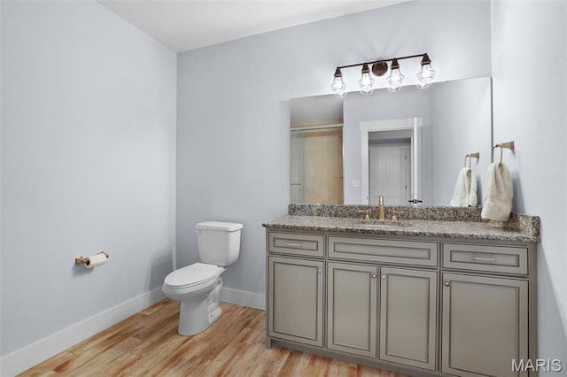 1316 Breezeridge Dr, Des Peres, MO 63131 - full bath featuring toilet, vanity, wood finished floors, baseboards, and a shower