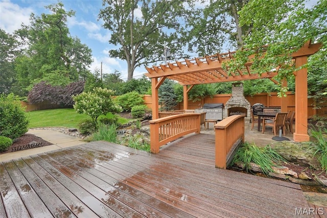 1316 Breezeridge Dr, Des Peres, MO 63131 - wooden deck with an outdoor stone fireplace, a pergola, and area for grilling