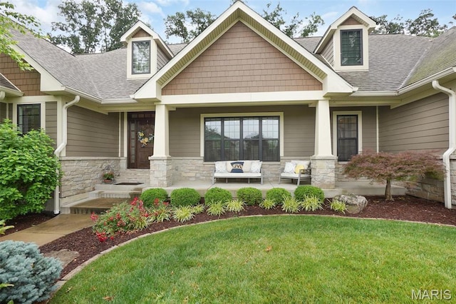 1316 Breezeridge Dr, Des Peres, MO 63131 - craftsman-style home with covered porch, stone siding, a front yard, and roof with shingles