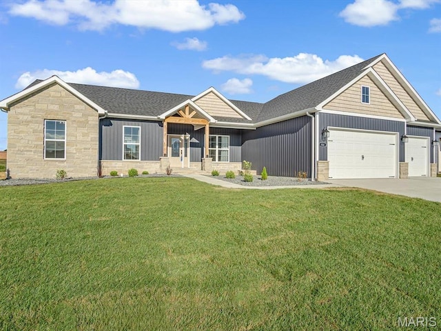 484 Hayden Dr, Waterloo, IL 62298 - view of front of house with stone siding, board and batten siding, a front yard, and a garage