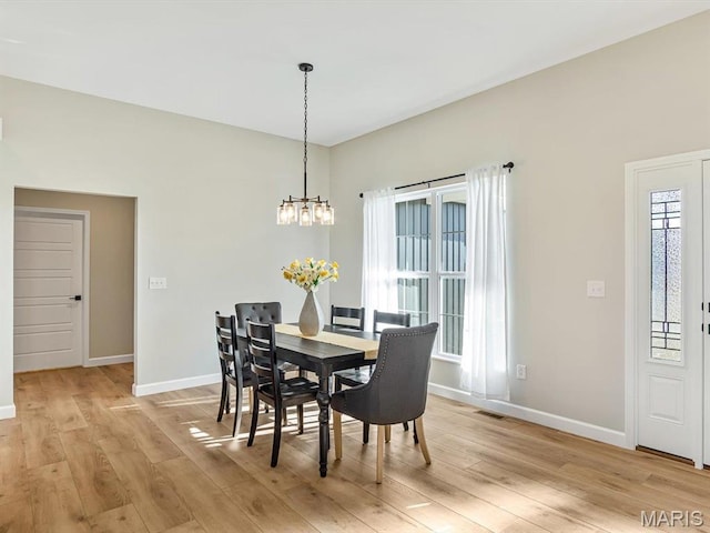 484 Hayden Dr, Waterloo, IL 62298 - dining area with a chandelier, light wood-style floors, and baseboards