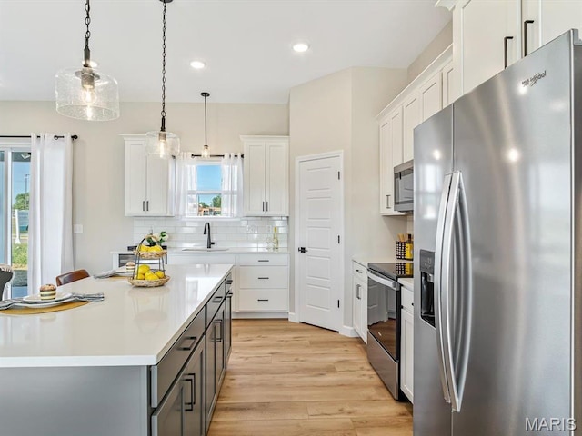 484 Hayden Dr, Waterloo, IL 62298 - kitchen with stainless steel appliances, a sink, gray cabinetry, light wood-style flooring, and light countertops
