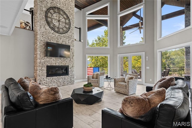 2262 Brown Rd, Van Buren, MO 63965 - living area with high vaulted ceiling, a fireplace, a ceiling fan, baseboards, and wood finished floors