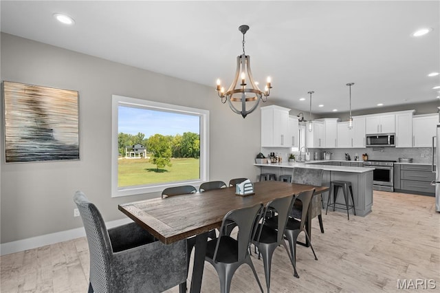 2262 Brown Rd, Van Buren, MO 63965 - dining room with a chandelier, light wood-style floors, recessed lighting, and baseboards