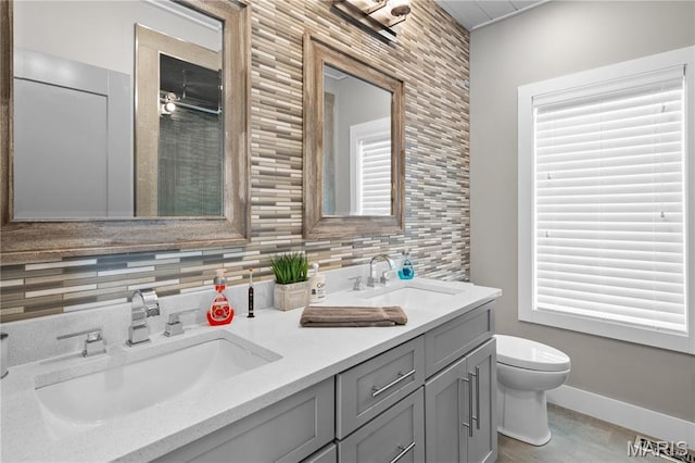2262 Brown Rd, Van Buren, MO 63965 - bathroom featuring toilet, double vanity, tasteful backsplash, and baseboards