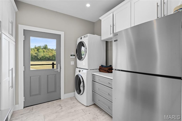 2262 Brown Rd, Van Buren, MO 63965 - washroom with stacked washing machine and dryer, light wood-style floors, recessed lighting, and baseboards