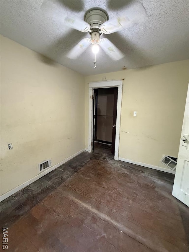 2213 Johnson St, Alton, IL 62002 - spare room with baseboards, a textured ceiling, and a ceiling fan