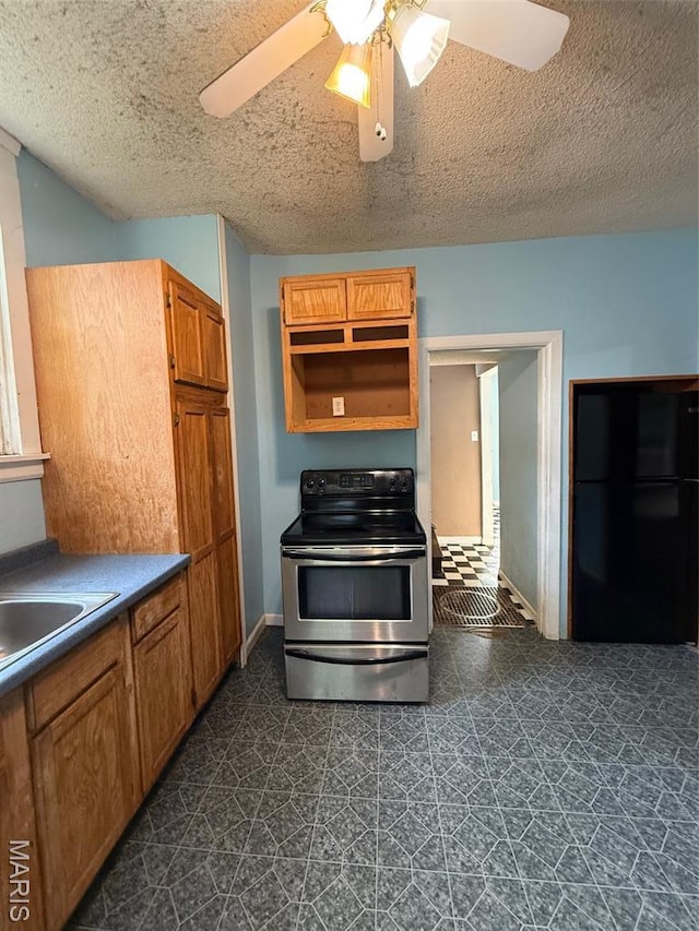 2213 Johnson St, Alton, IL 62002 - kitchen with stainless steel electric stove, ceiling fan, a textured ceiling, brown cabinetry, and a sink