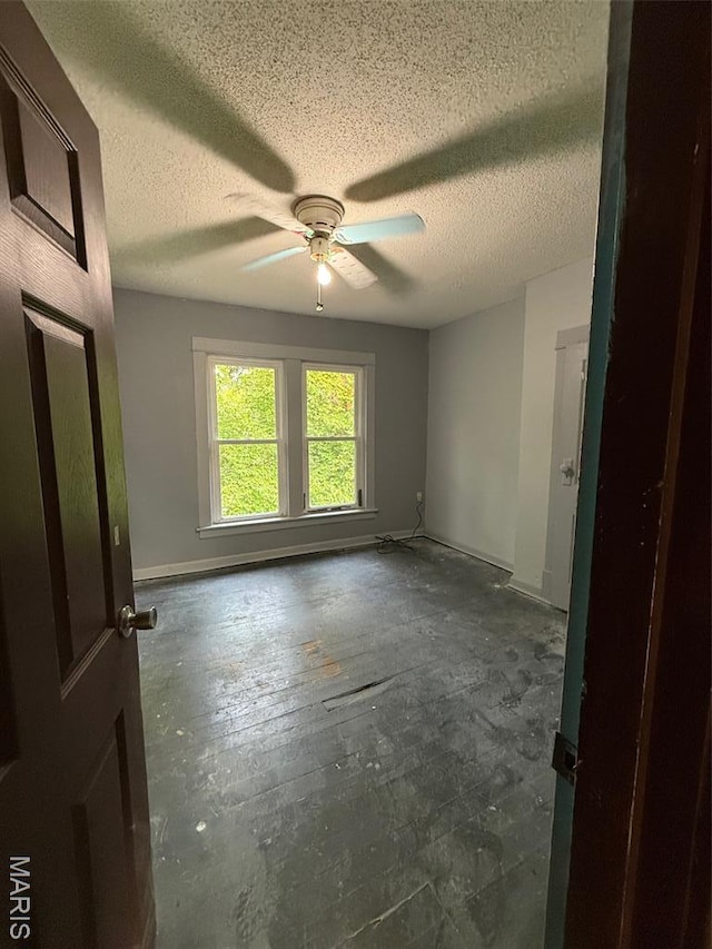 2213 Johnson St, Alton, IL 62002 - spare room featuring a ceiling fan, a textured ceiling, and baseboards