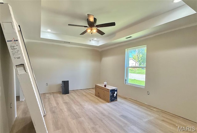 500 W Pacific St, Pacific, MO 63069 - empty room with a raised ceiling, light wood-type flooring, recessed lighting, and ceiling fan