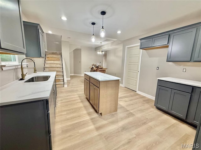 500 W Pacific St, Pacific, MO 63069 - kitchen with a kitchen island, light wood-type flooring, decorative light fixtures, recessed lighting, and light stone counters