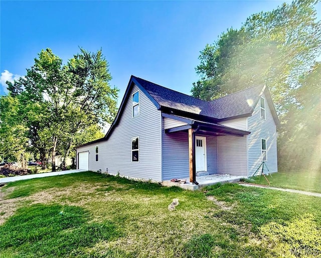 500 W Pacific St, Pacific, MO 63069 - view of side of property featuring a garage, a lawn, and driveway